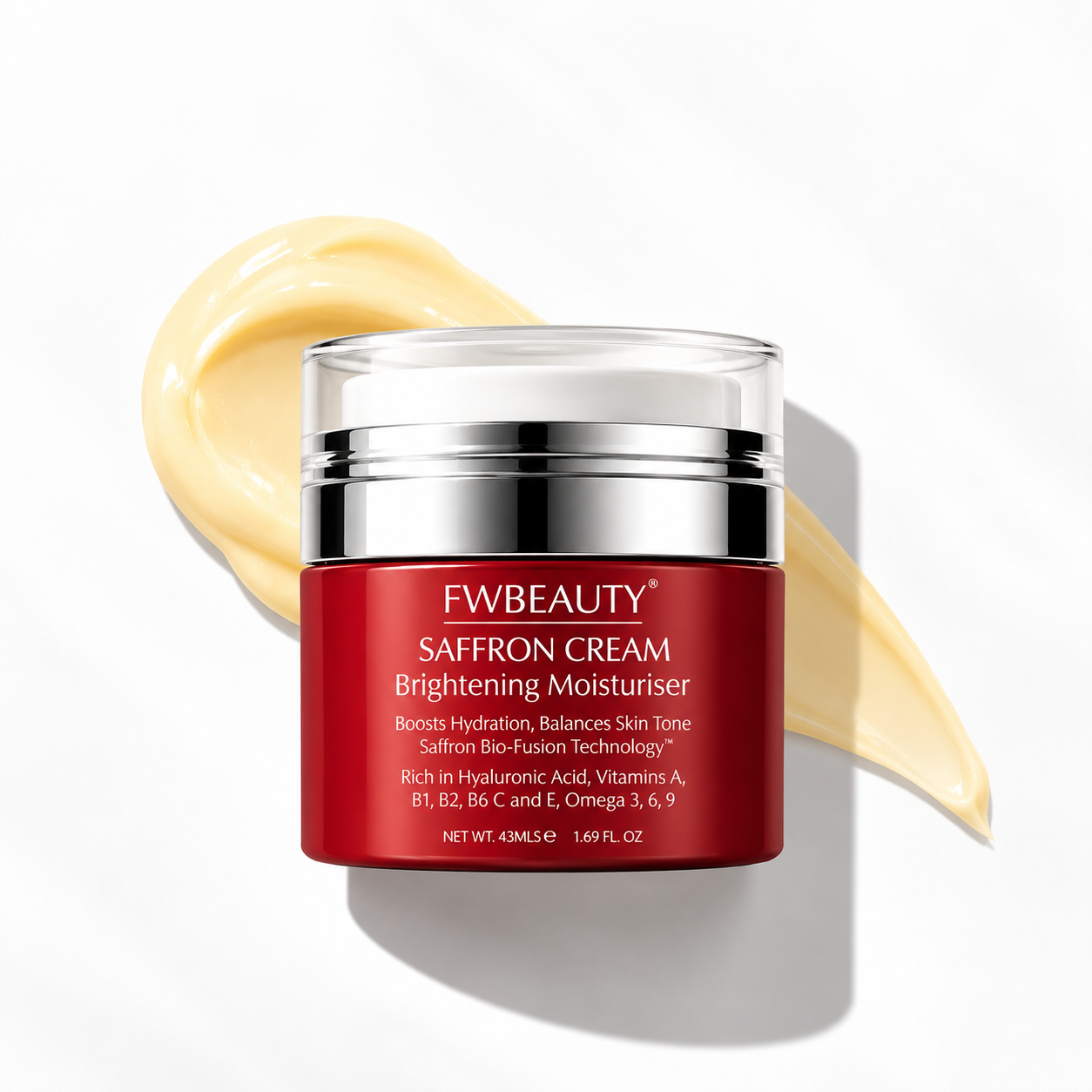FWBEAUTY Saffron Cream Brightening Moisturiser in a red jar with a silver lid, set against a white background with a diagonal smear of pale yellow cream behind it.