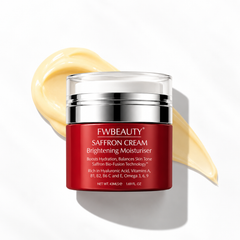 FWBEAUTY Saffron Cream Brightening Moisturiser in a red jar with a silver lid, set against a white background with a diagonal smear of pale yellow cream behind it.