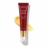 FWBEAUTY Saffron Under Eye Night Repair eye cream in a dark red squeeze tube with a gold cap, shown with a smear of the pale yellow cream behind it on a white background.