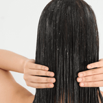 Model applying Rosemary & Clove conditioner to hair 