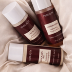 Three bottles of FW Beauty skincare products on a beige fabric background