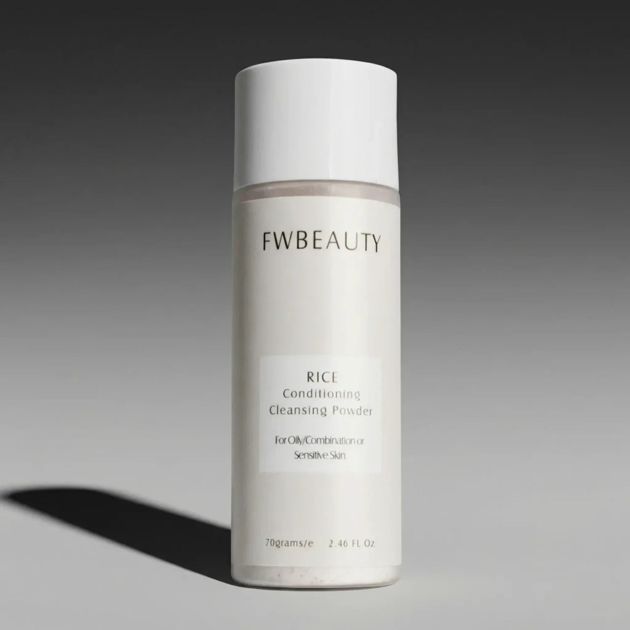 FWBeauty rice conditioning cleansing powder bottle on a gray background