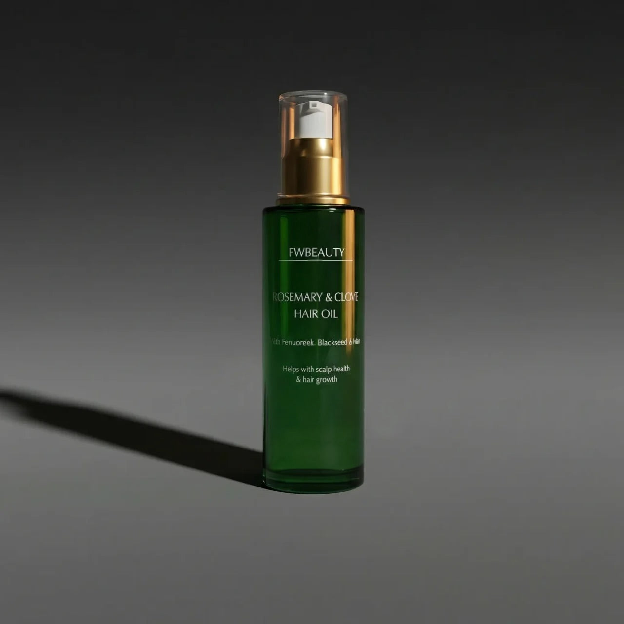 Green hair oil bottle with gold cap on a dark gray background