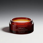 Red jar of FW Beauty saffron cleansing balm on a gray background