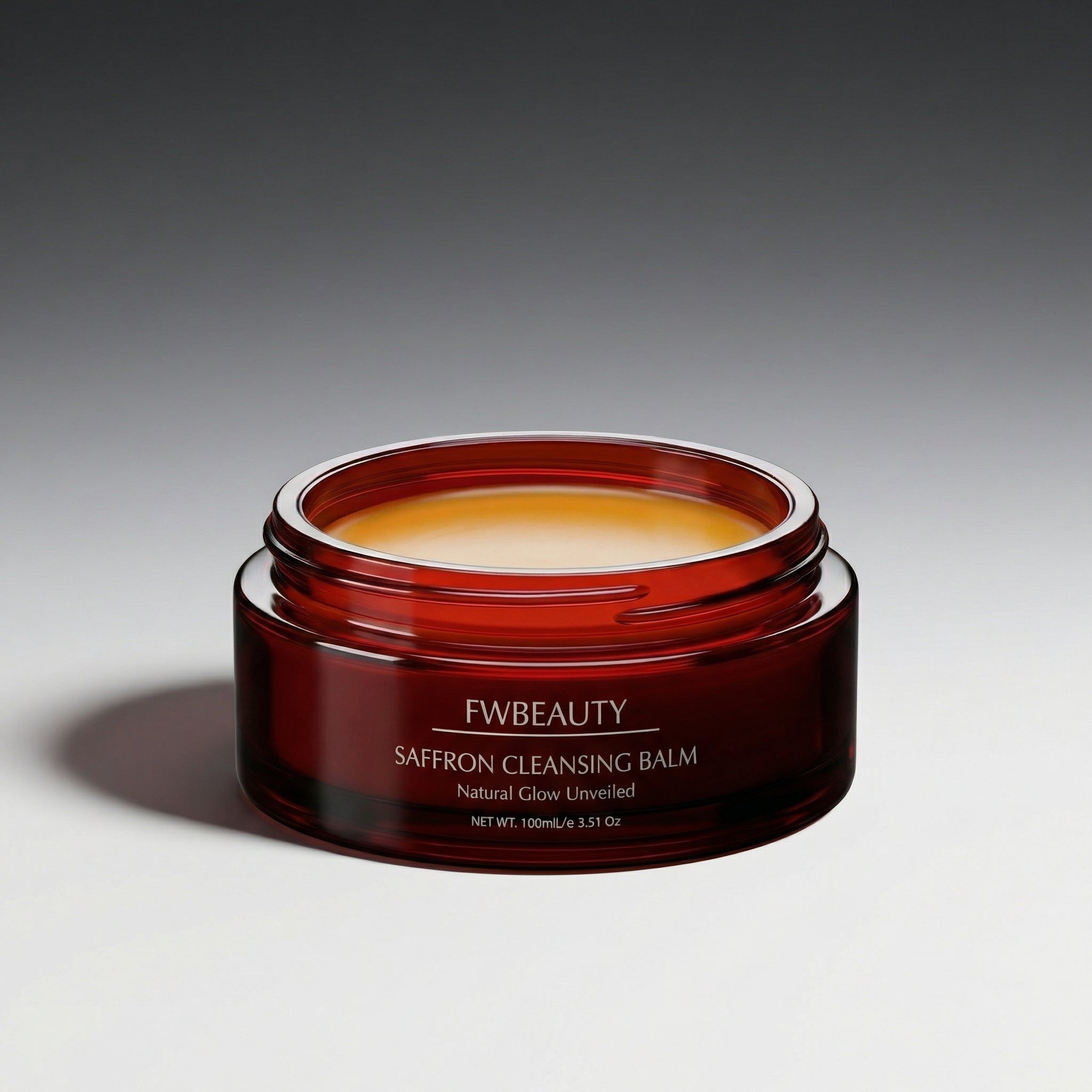 Red jar of FW Beauty saffron cleansing balm on a gray background