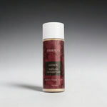 Saffron brightening cleansing powder bottle with red label on gray background