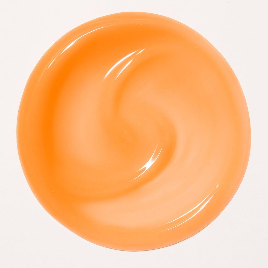 Saffron Lip Oil Swatch FWBEAUTY. 

Circular swatch of orange oil like product on white background. 