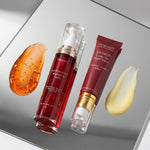 Two skincare products with saffron extract on a reflective surface